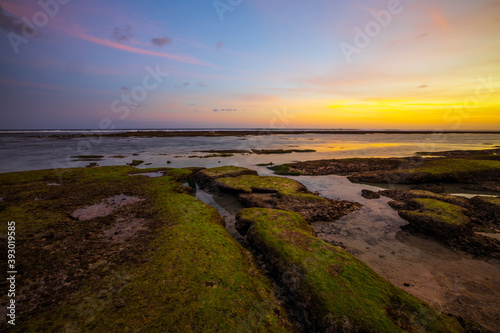 Seascape. Beach with rocks and stones. Low tide. Sunset time. Slow shutter speed. Soft focus. Melasti beach  Bali  Indonesia