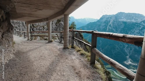 A man walks along the road high in the mountains.