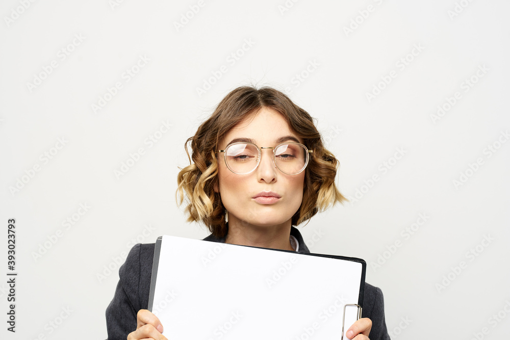 Business woman with a folder of documents on a light background cropped view and shirt suit Business woman with a folder of documents on a light background cropped view and shirt suit