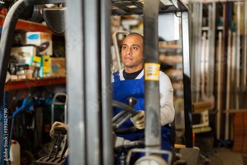 Positive forklift driver driving at hardware store