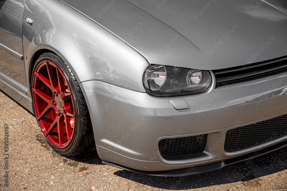 Moscow, Russia - July 19, 2019: Tuned low sport hatchback with red Candy  colored alloy wheels. Golf mk 4 is on the street. Stanced lowrider with badboy  hood Stock Photo | Adobe Stock