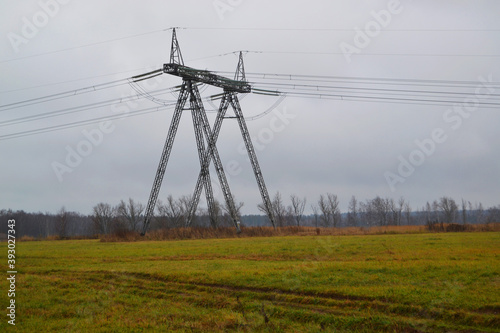 High-voltage electric pole with wires in the field