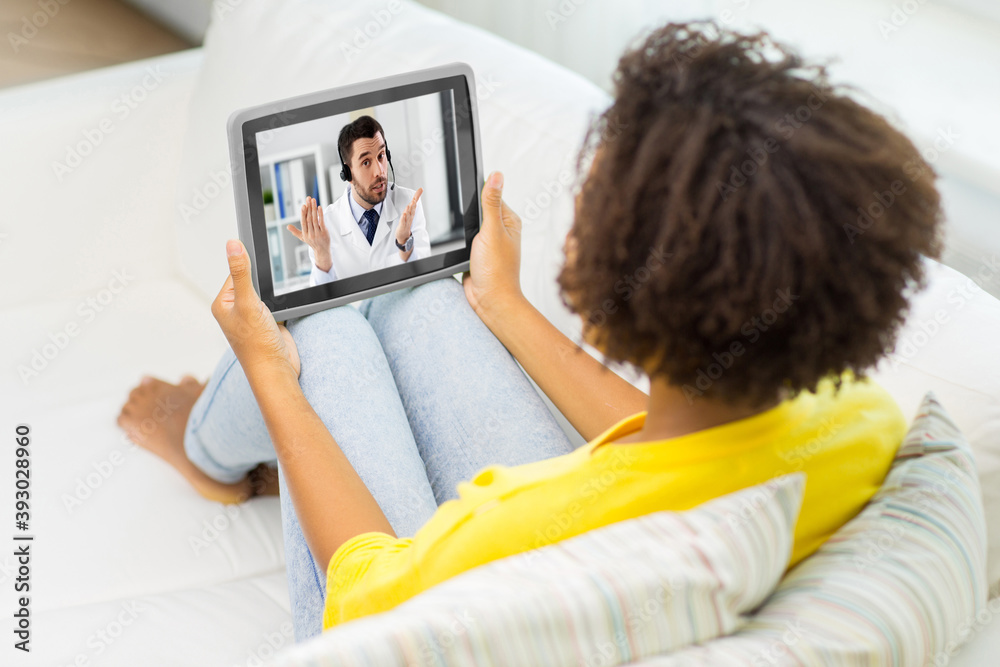 medicine, healthcare and technology concept - african american woman having video call or online consultation with doctor on tablet pc computer at home medicine, healthcare and technology concept - african american woman having video call or online consultation with doctor on tablet pc computer at home