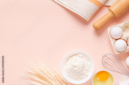 Ingredients for baking on light pink background.