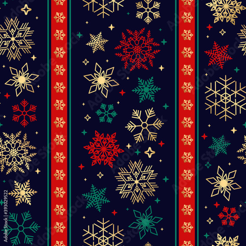 A Bright Seamless ribbon with Christmas snowflake pattern. Green, red and gold colors. Vertical tape. Luxurious and richly decorated holiday ornament