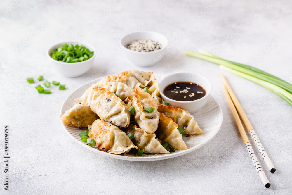 Fried dumplings gyoza with soy sauce, and chopsticks. Fried dumplings gyoza with soy sauce, and chopsticks.