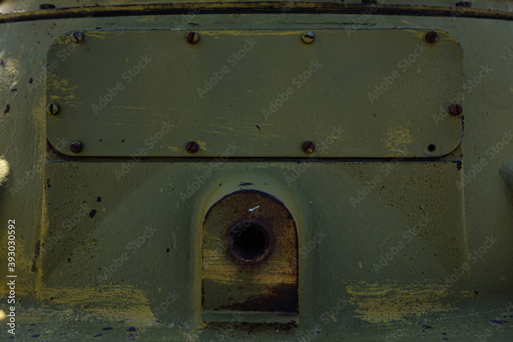 Metal sheet, garage detail, wall screwed in with bolts, nuts, screws, traces of green, emerald paint with elements of rust and metal corrosion, cracks, barn lock and grate Metal sheet, garage detail, wall screwed in with bolts, nuts, screws, traces of green, emerald paint with elements of rust and metal corrosion, cracks, barn lock and grate