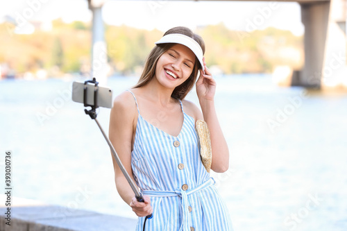 Beautiful young woman takin...