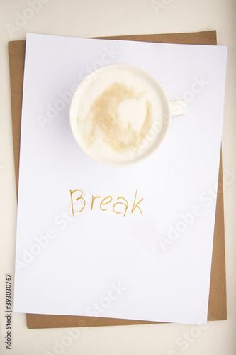 A break during work. Time to rest. Cup of coffee on a white background with the inscription 