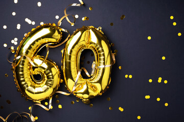 Gold foil balloon number, digit sixty. Birthday greeting card with inscription 60. Anniversary celebration event. Banner. Golden numeral, black background. Numerical digit, light bokeh, glitter.