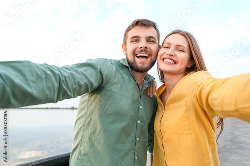 Young couple taking selfie ...
