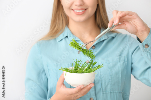 Young woman with wheatgrass...