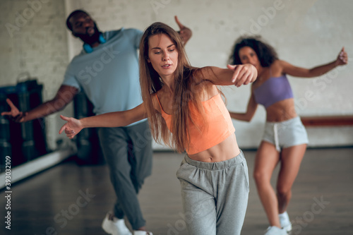 Woman learning hip-hop choreography with her groupmates
