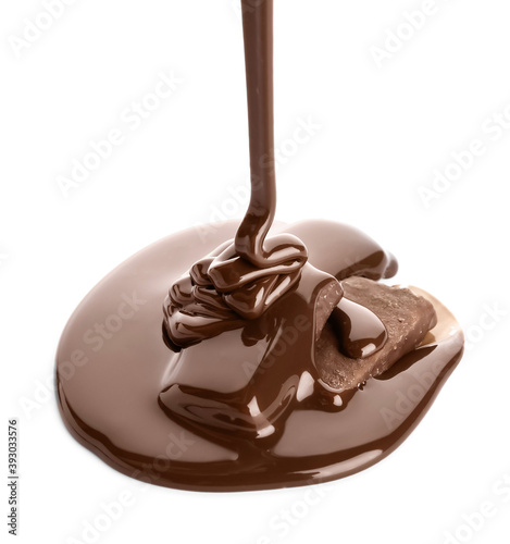 Pouring of melted chocolate on sweet candies against white background