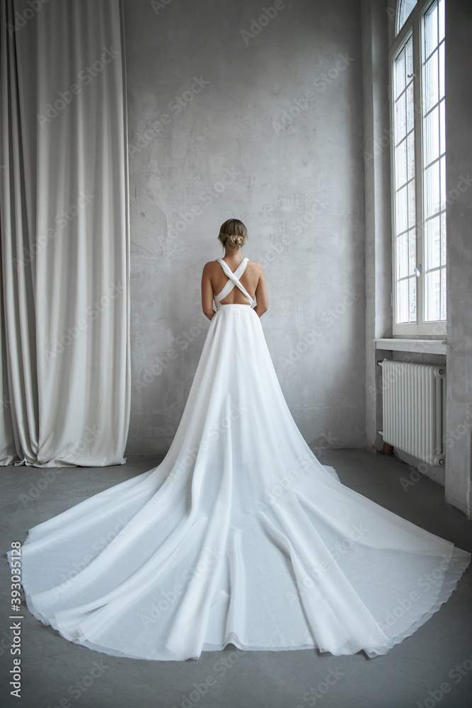 Beautiful slender woman in white wedding dress, new collection of dresses for the bride. Noise, out of focus Beautiful slender woman in white wedding dress, new collection of dresses for the bride. Noise, out of focus
