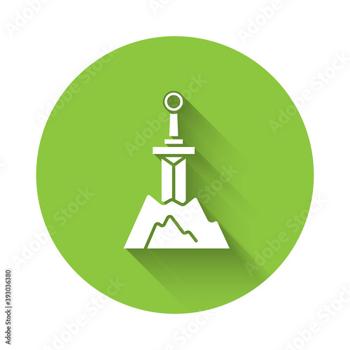 White Sword in the stone icon isolated with long shadow. Excalibur the sword in the stone from the Arthurian legends. Green circle button. Vector.
