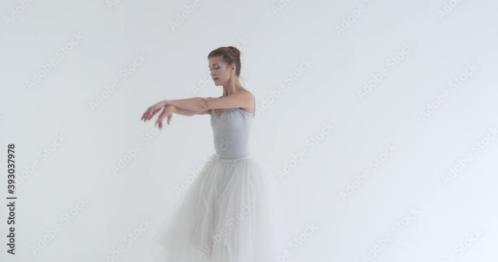 Elegant female in a white tutu, dance ballet and perform choreographic elements on a white background, rehearsal. Elegant female in a white tutu, dance ballet and perform choreographic elements on a white background, rehearsal.