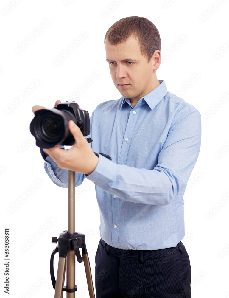 Obraz premium portrait of male photographer or videographer taking photo or shooting video with modern dslr camera on tripod isolated on white