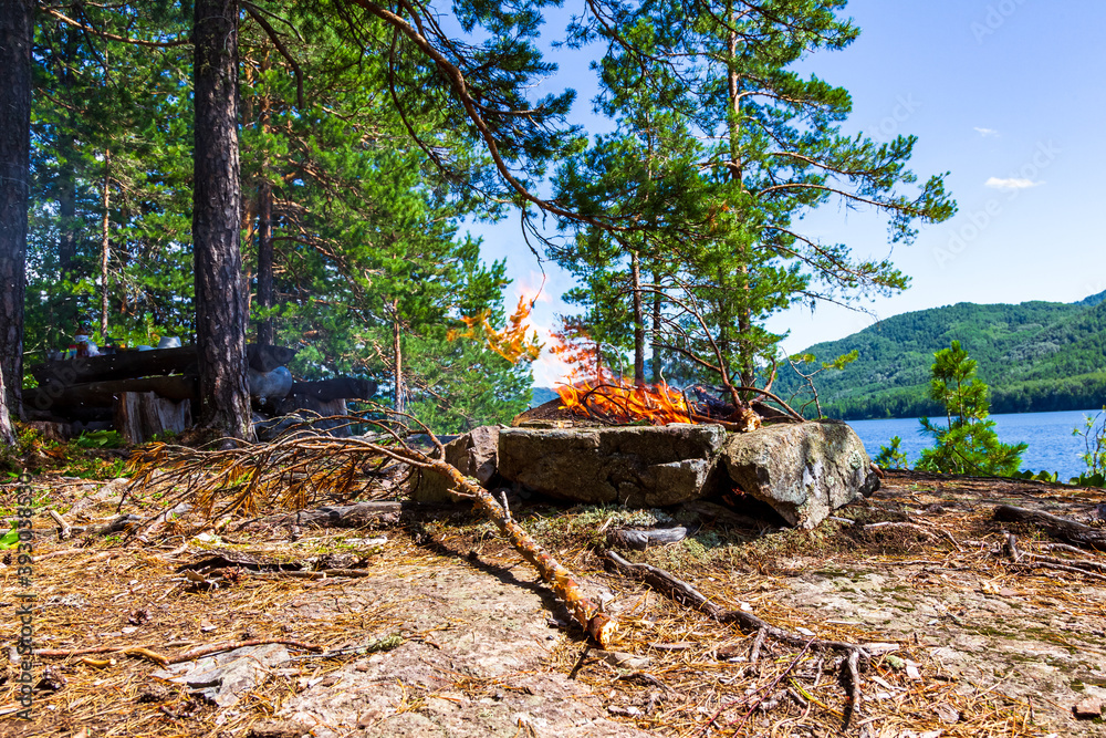 Fishermen's camp on the island with a bonfire. Lake Tagasuk. Krasnoyarsk Territory, Siberia, Russia Fishermen's camp on the island with a bonfire. Lake Tagasuk. Krasnoyarsk Territory, Siberia, Russia