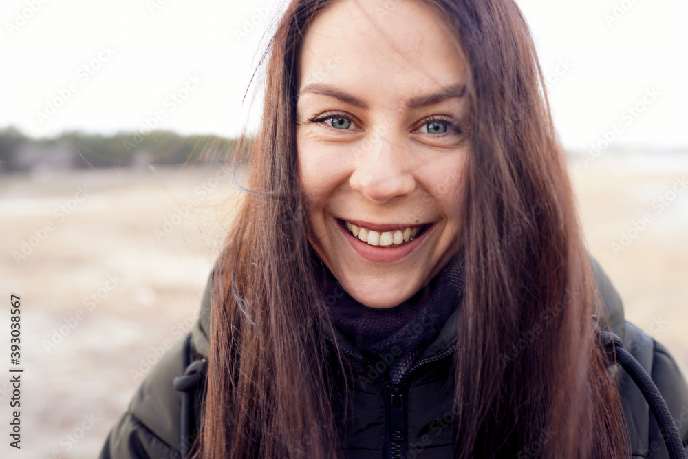 Happy smiling caucasian woman with dark hair in winter jacket Happy smiling caucasian woman with dark hair in winter jacket