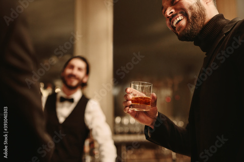 Man with a drink at party photo