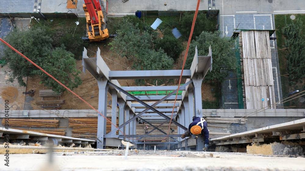 Workers install steel structures at construction sites