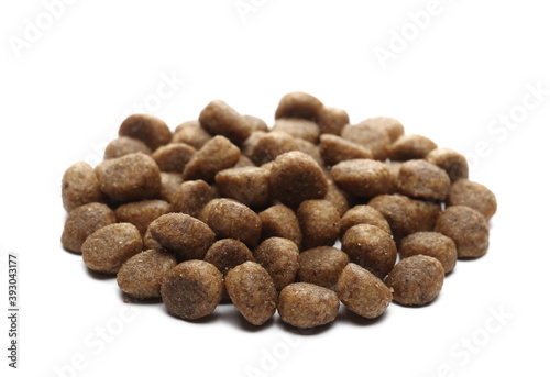 Dog food, dry granules for puppies isolated on white background