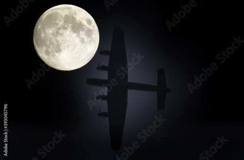 Fototapeta Silhouetted Lancaster bomber and moon composite