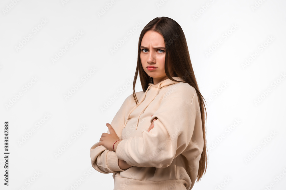 Photo of Offended girl with Holding hands crossed, looking at camera Photo of Offended girl with Holding hands crossed, looking at camera
