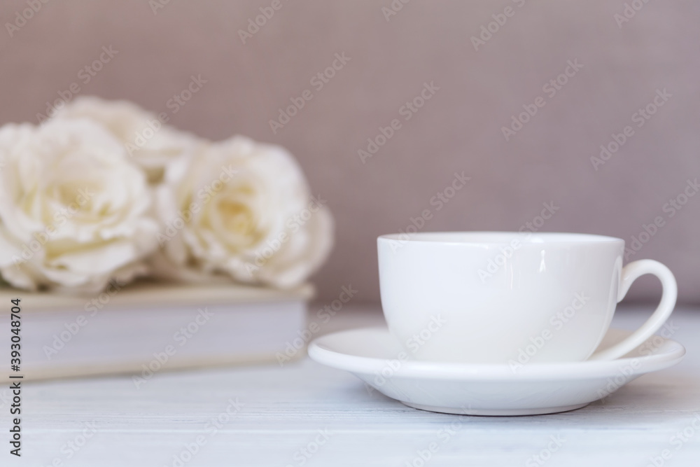 Mockup - White cup on white wooden background with roses. Wedding, romantic