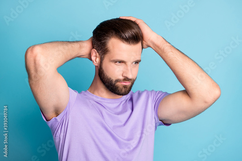 Photo of young charming man hands touch head enjoy haircut look empty space isolated over blue color background © deagreez