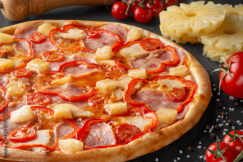 pizza on black background with ingredients