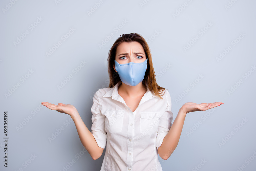 Really Photo portrait of shocked frustrated young lady in blue fabric face mask isolated on white colored background holding blank spaces Really Photo portrait of shocked frustrated young lady in blue fabric face mask isolated on white colored background holding blank spaces