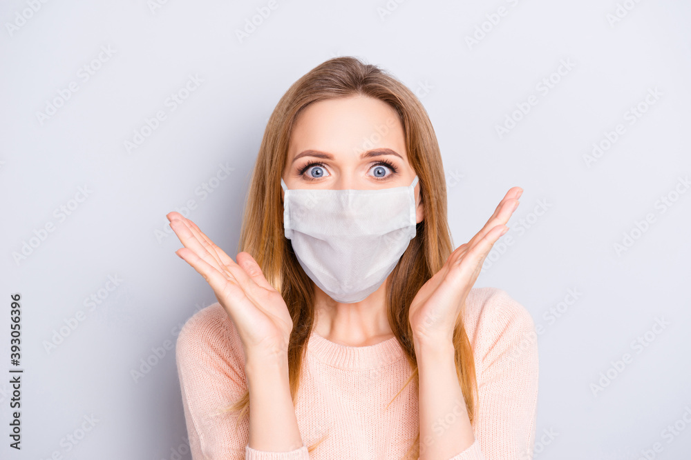 Photo portrait of excited girl wearing white face mask isolated on grey colored background Photo portrait of excited girl wearing white face mask isolated on grey colored background