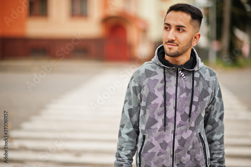 Student kuwaiti man wear at hoodie, walking crosswalk. photo
