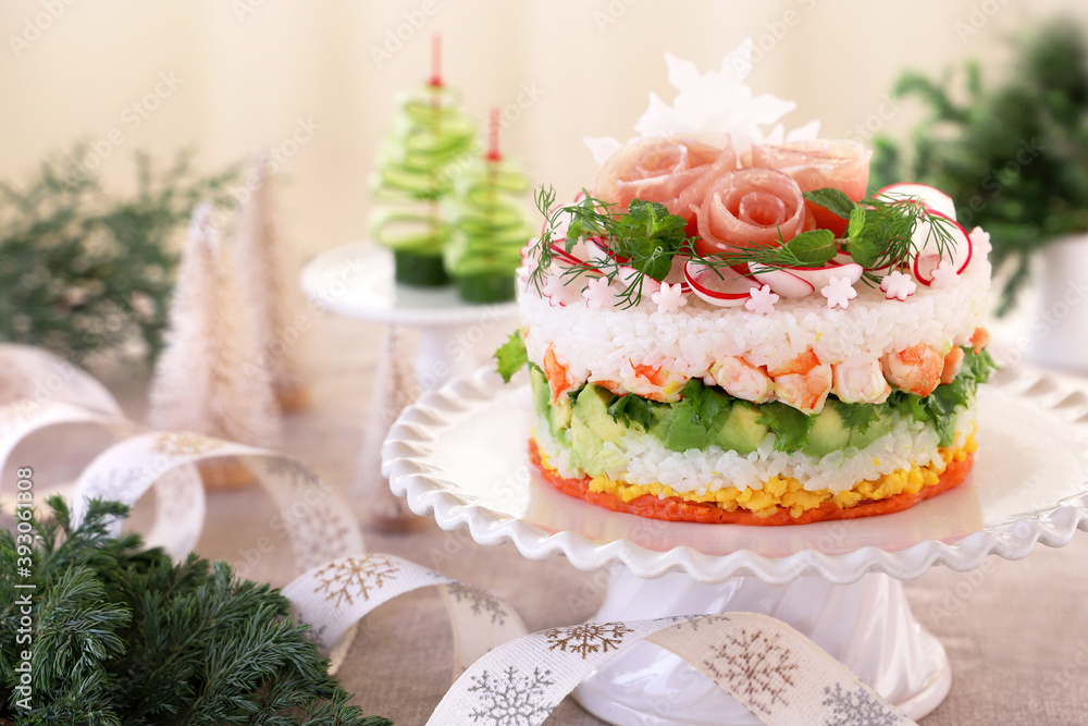 Christmas layered salad with salmon, avocado, shrimp, and vinegared rice on holiday decoration table. ケーキ寿司 クリスマス Christmas layered salad with salmon, avocado, shrimp, and vinegared rice on holiday decoration table. ケーキ寿司 クリスマス