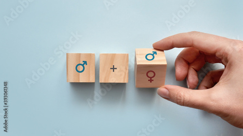 Wooden cubes with the image of a male and female gender sign. The choice of the person: relationship with a man or a woman photo