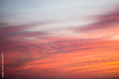 Photograph of the sunset sky dyed in orange as a background material © Wako