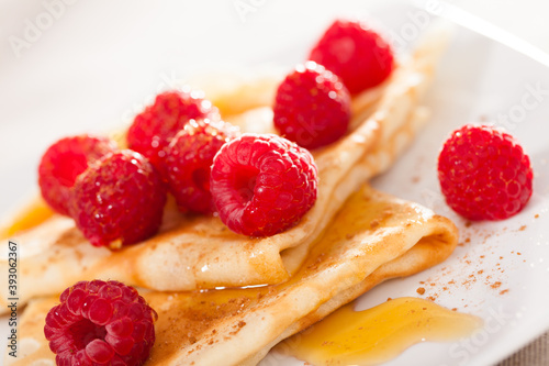 delicious  pancakes with fresh raspberries and honey