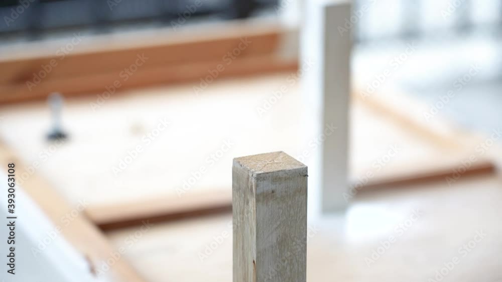 Slow motion: Close up of Wood Worker using an electric hand drill to drill a hole Wood. man carpenter hands using Power drill drilling into wooden Slow motion: Close up of Wood Worker using an electric hand drill to drill a hole Wood. man carpenter hands using Power drill drilling into wooden