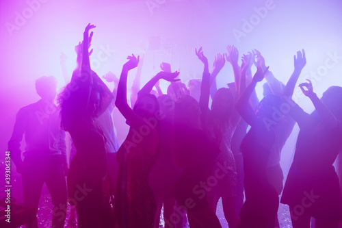 Photo of people pretty flirty girls dance raise hands party event wear stylish outfit glossy dress modern club indoors