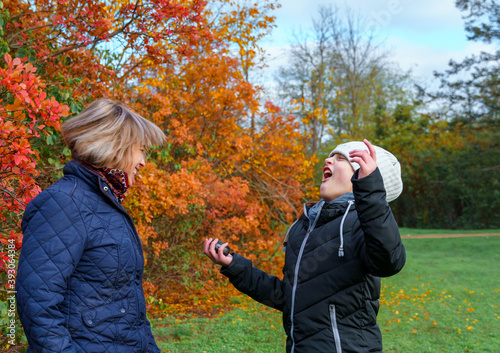 mother and daughter playing and having fun in autumn park, happy people together, parent and children, beautiful nature © soleg