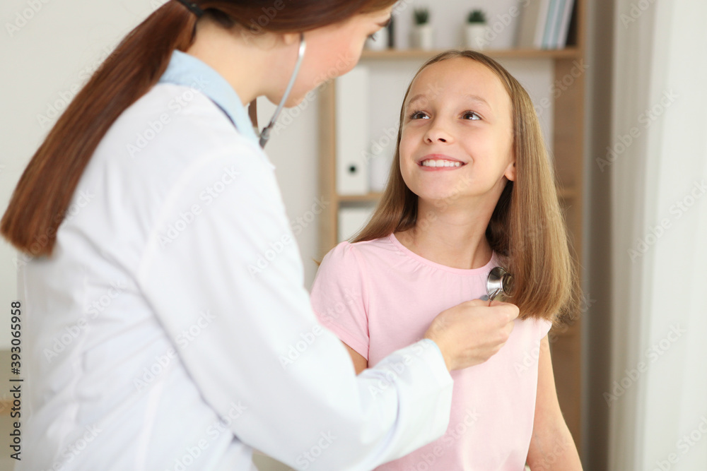 Young girl doctor pediatrician makes a checkup to a little girl Young girl doctor pediatrician makes a checkup to a little girl