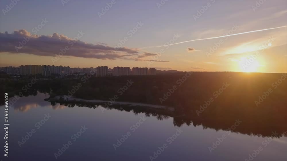 Flight over the lake during sunset overlooking the city with beautiful clouds, Ukraine Kiev. Flight over the lake during sunset overlooking the city with beautiful clouds, Ukraine Kiev.