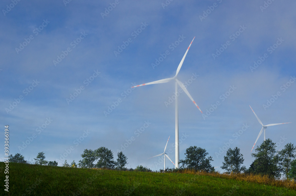 WIND FARM - Turbines against a blue sky in passing clouds of fog
WIND FARM - Turbines against a blue sky in passing clouds of fog