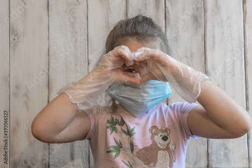 Little girl with a medical mask and disposable gloves. Antivirus. Coronavirus. Hygiene. Prevention Epidemic. Pandemic. The medicine. The fight against the virus. Virus.