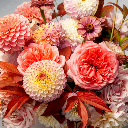 Floral composition of dahlia flowers  roses and autumn leaves. Arty  bright red and pink color  bouquet of flowers 