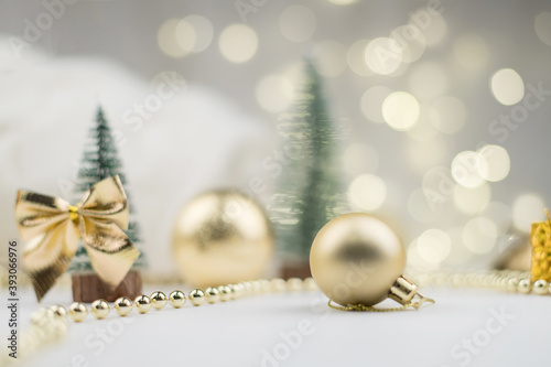 Little Christmas trees decorated and gifts for the new year on the bokeh background, new year composition