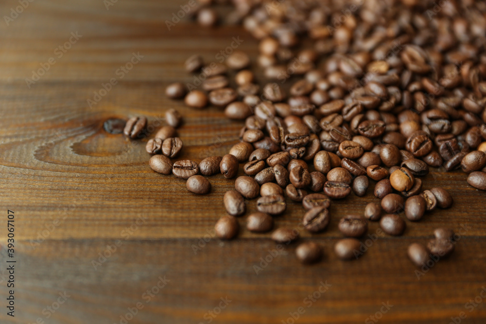 roasted coffee beans on dark wooden background roasted coffee beans on dark wooden background