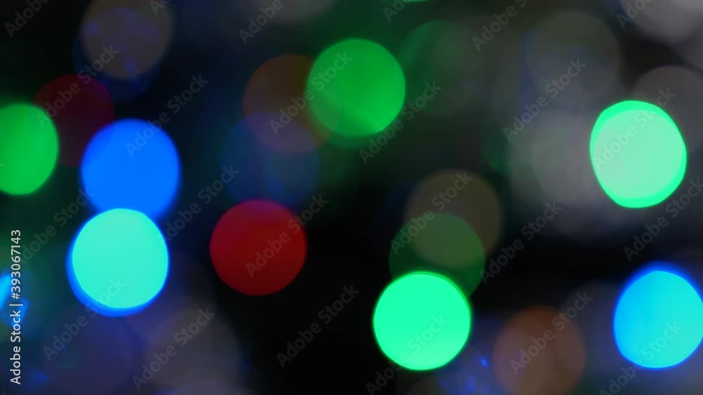 Multi color christmas lights flashing, round defocused lights for backgrounds Multi color christmas lights flashing, round defocused lights for backgrounds
